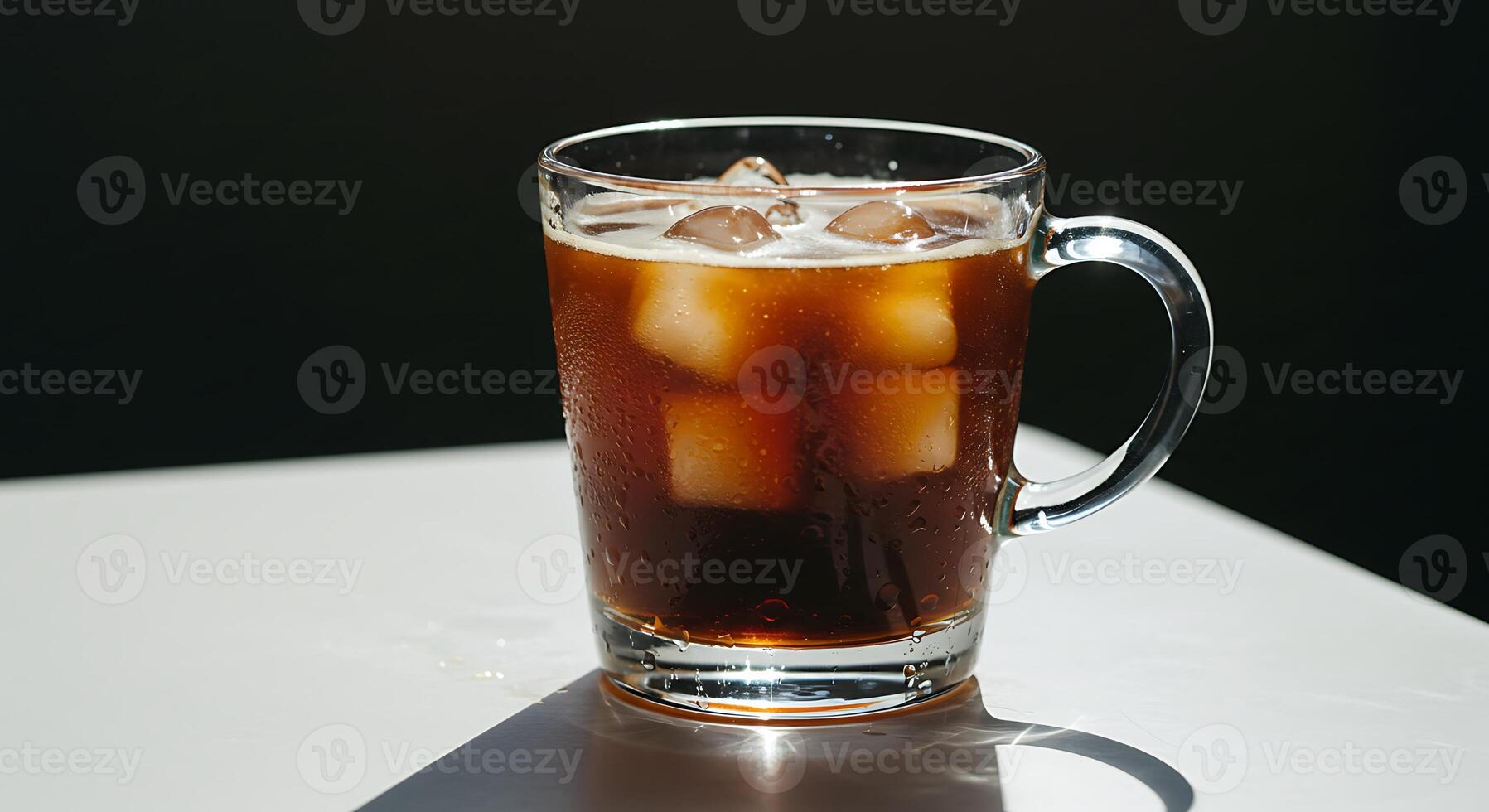 Refreshing Cold Brew Coffee with Ice in a Glass Mug on White Table photo