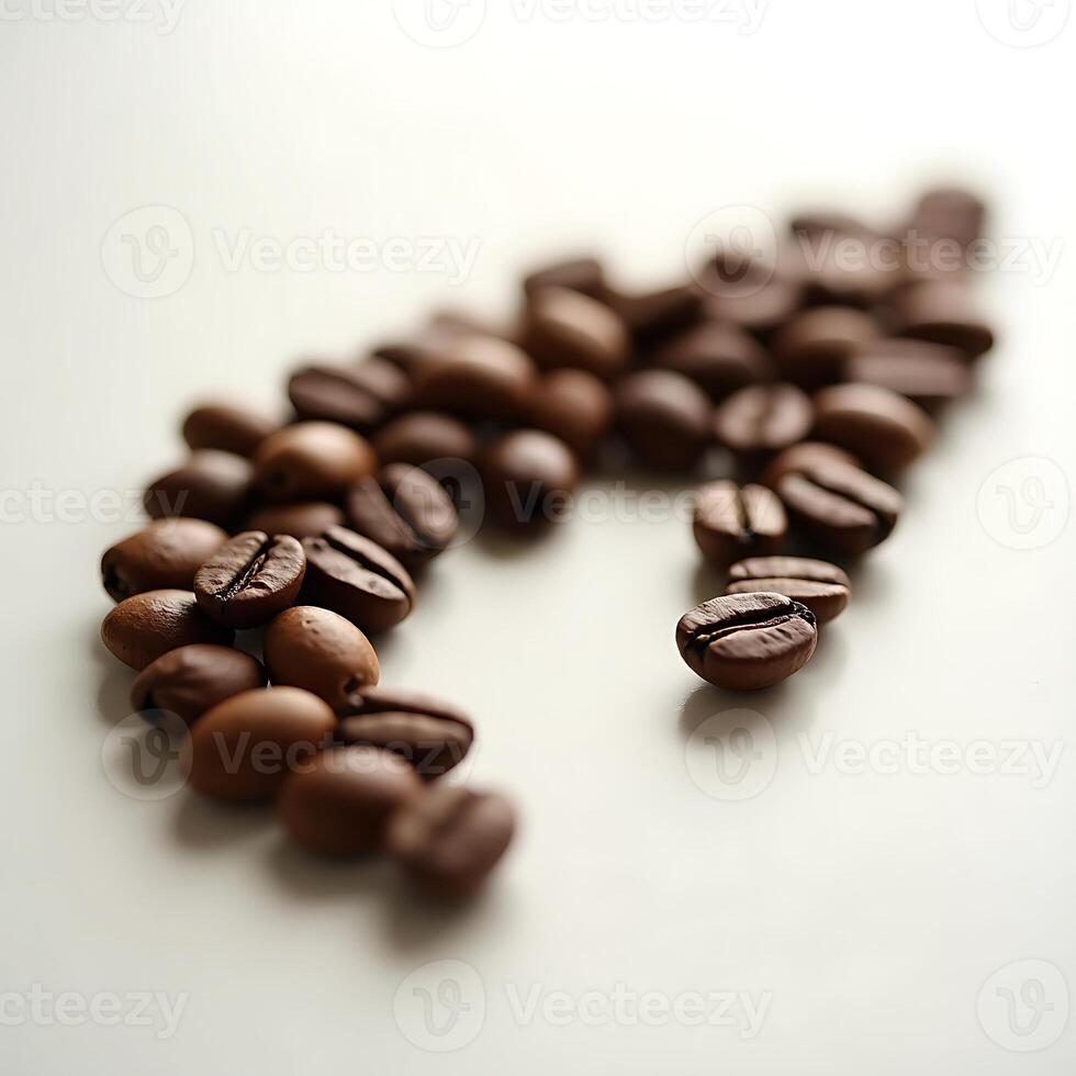 Scattered Coffee Beans on a White Surface in Soft Focus photo