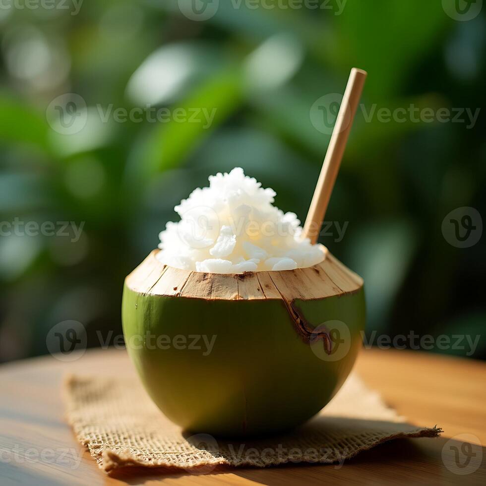 Coconut Water Drink with Ice and Wooden Straw on Table photo