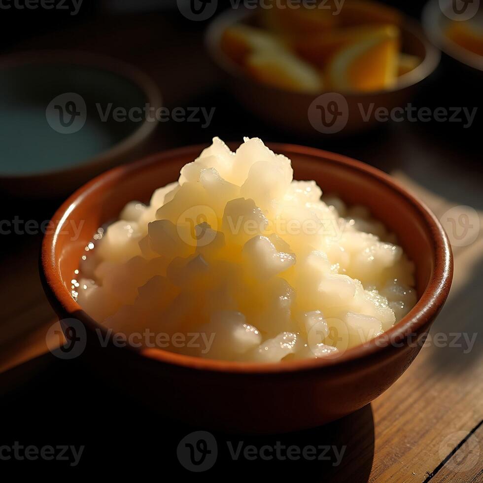 Serving of Grainy White Food in Bowl with Orange Slices photo