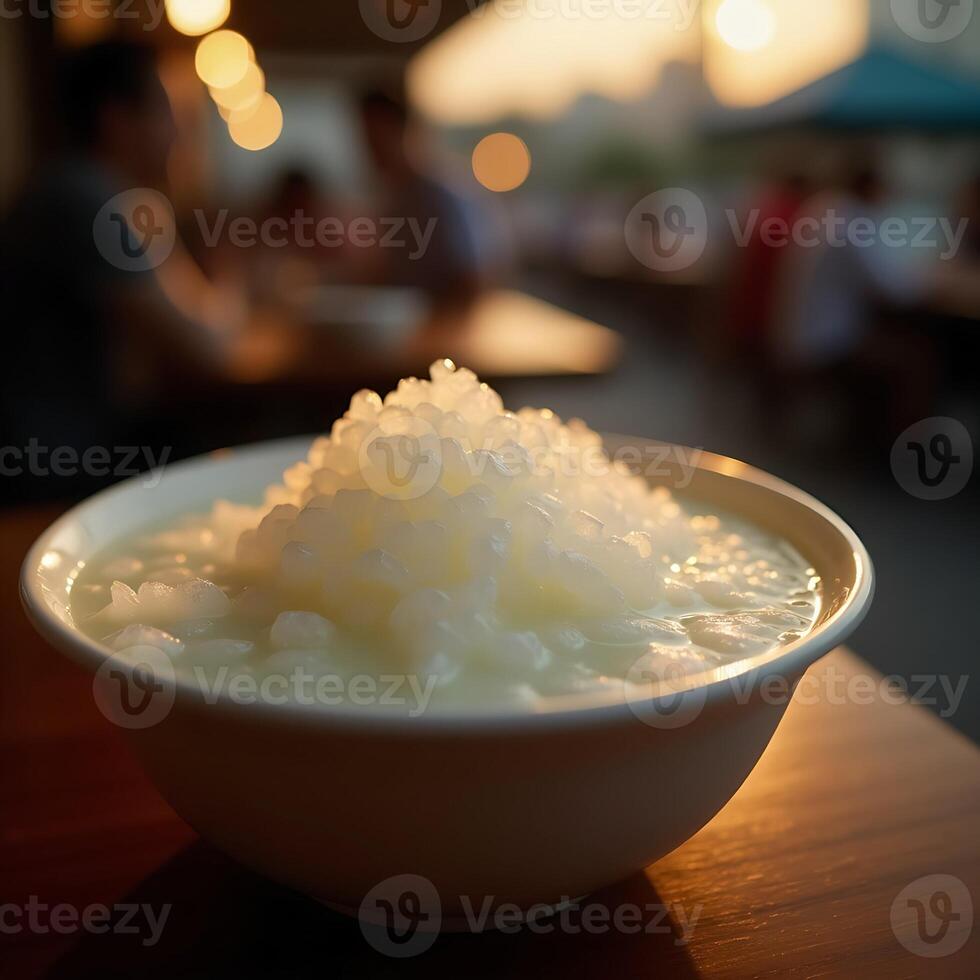 Eating White Dessert with Tapioca Pearls in Bowl at Restaurant photo