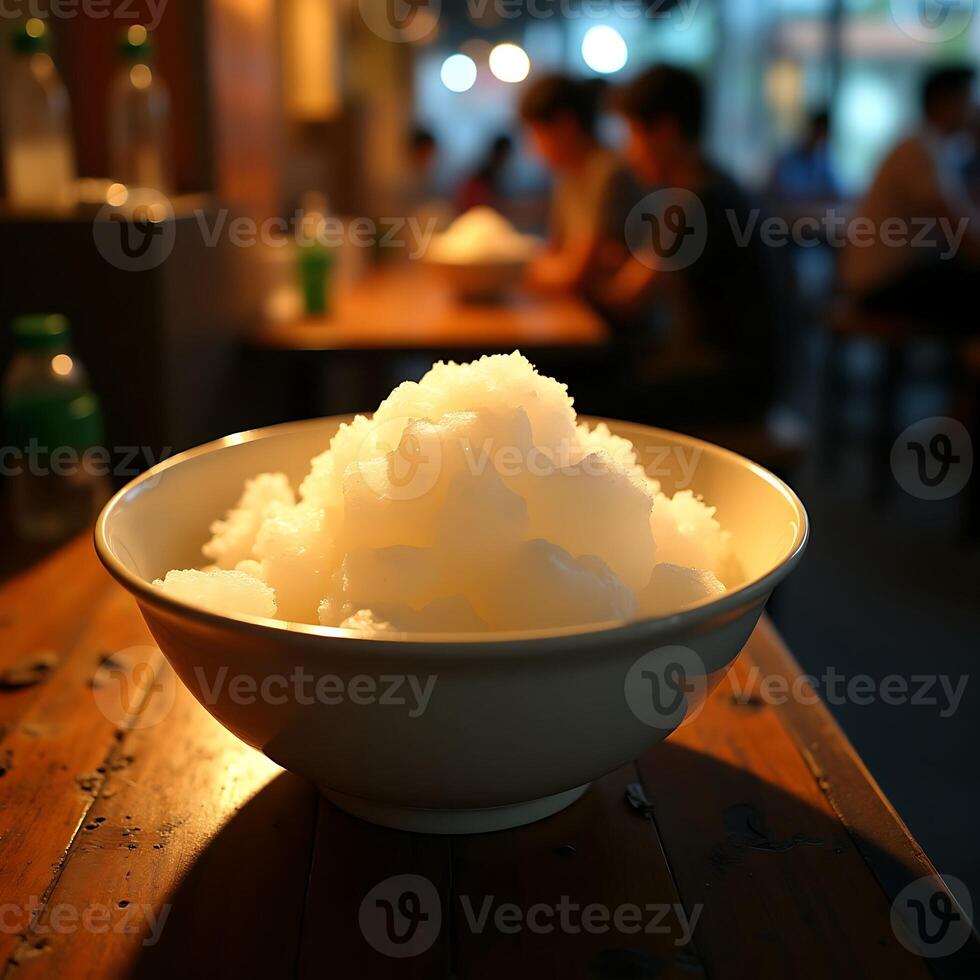 Shaved Ice Dessert in Bowl on Wooden Table at Restaurant photo