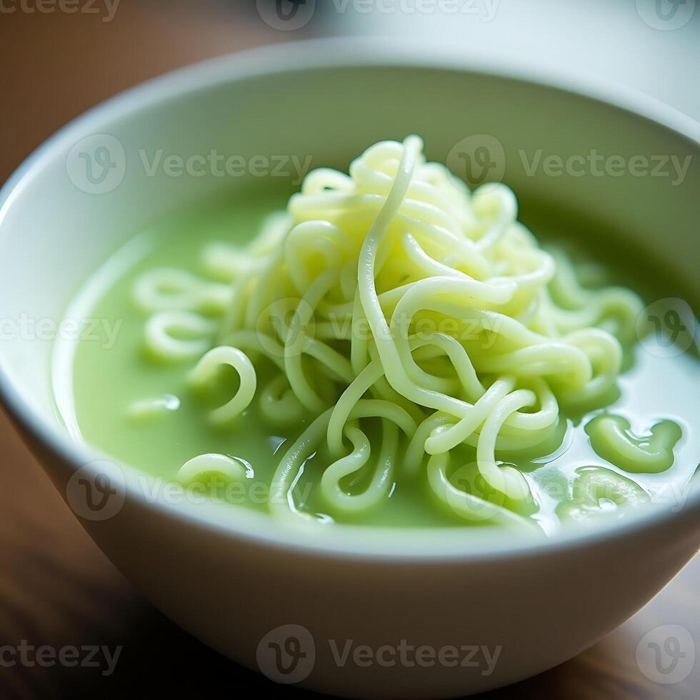 Serving of Noodle Soup with Light Green Broth in Bowl photo