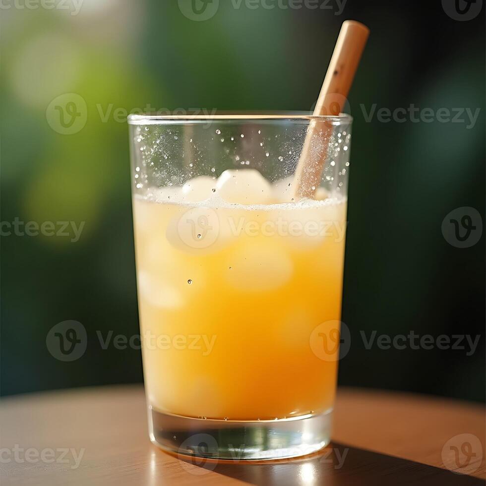 Refreshing Orange Drink with Ice and Wooden Straw Close Up photo