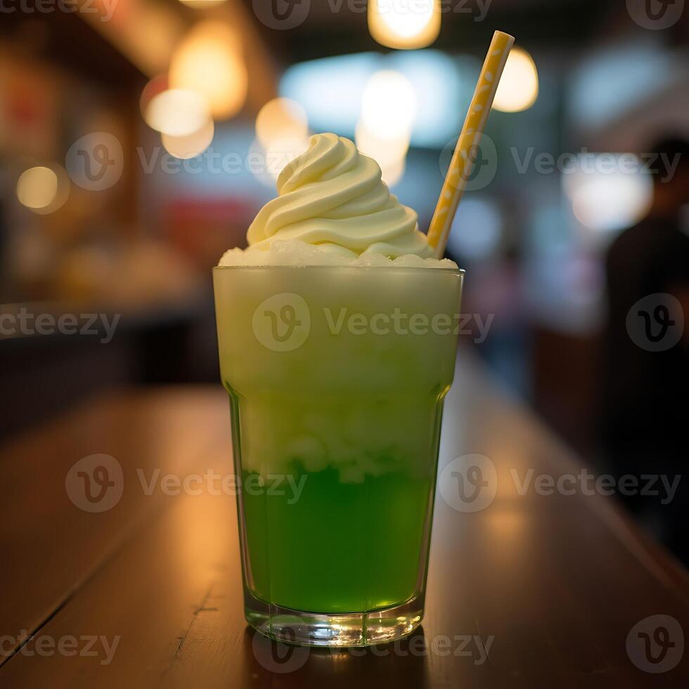 Refreshing Green Float Drink with Swirl Topping and Straw photo