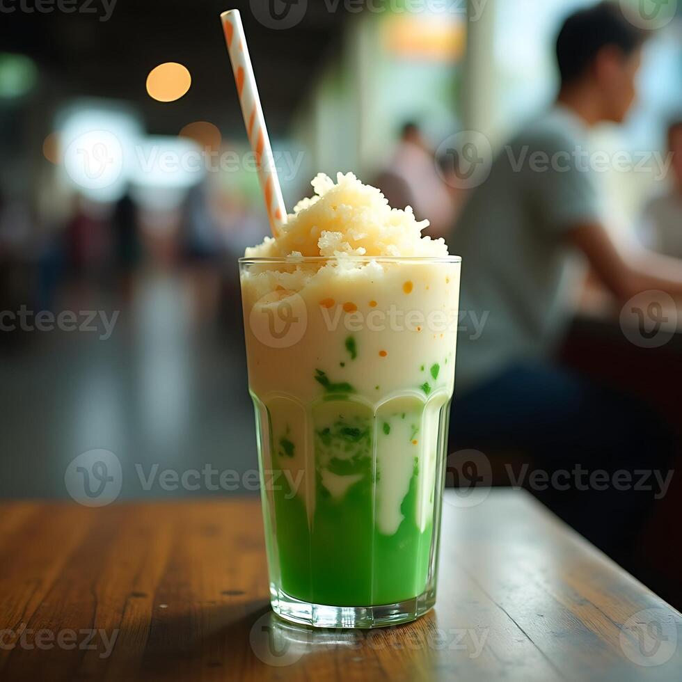 Refreshing Mixed Drink with Ice and Straw on Wooden Table photo