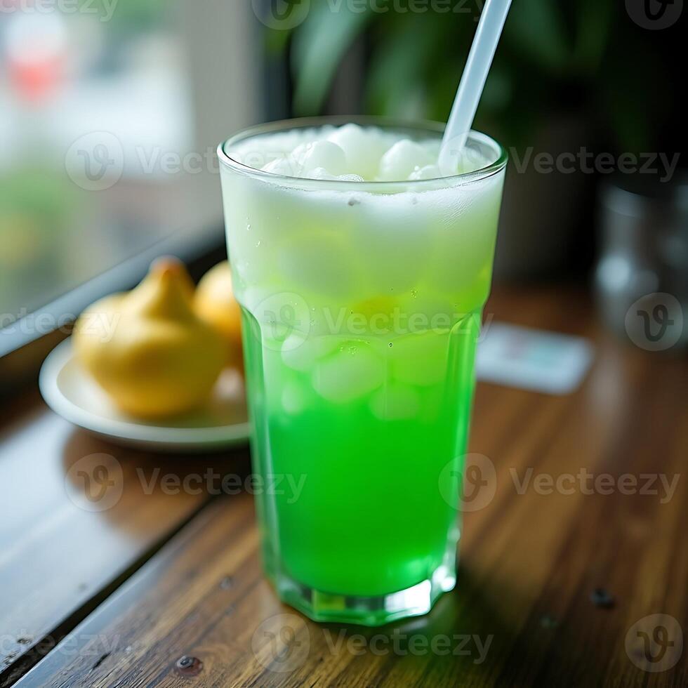 Refreshing Green Drink with Ice and Straw on Wooden Table photo