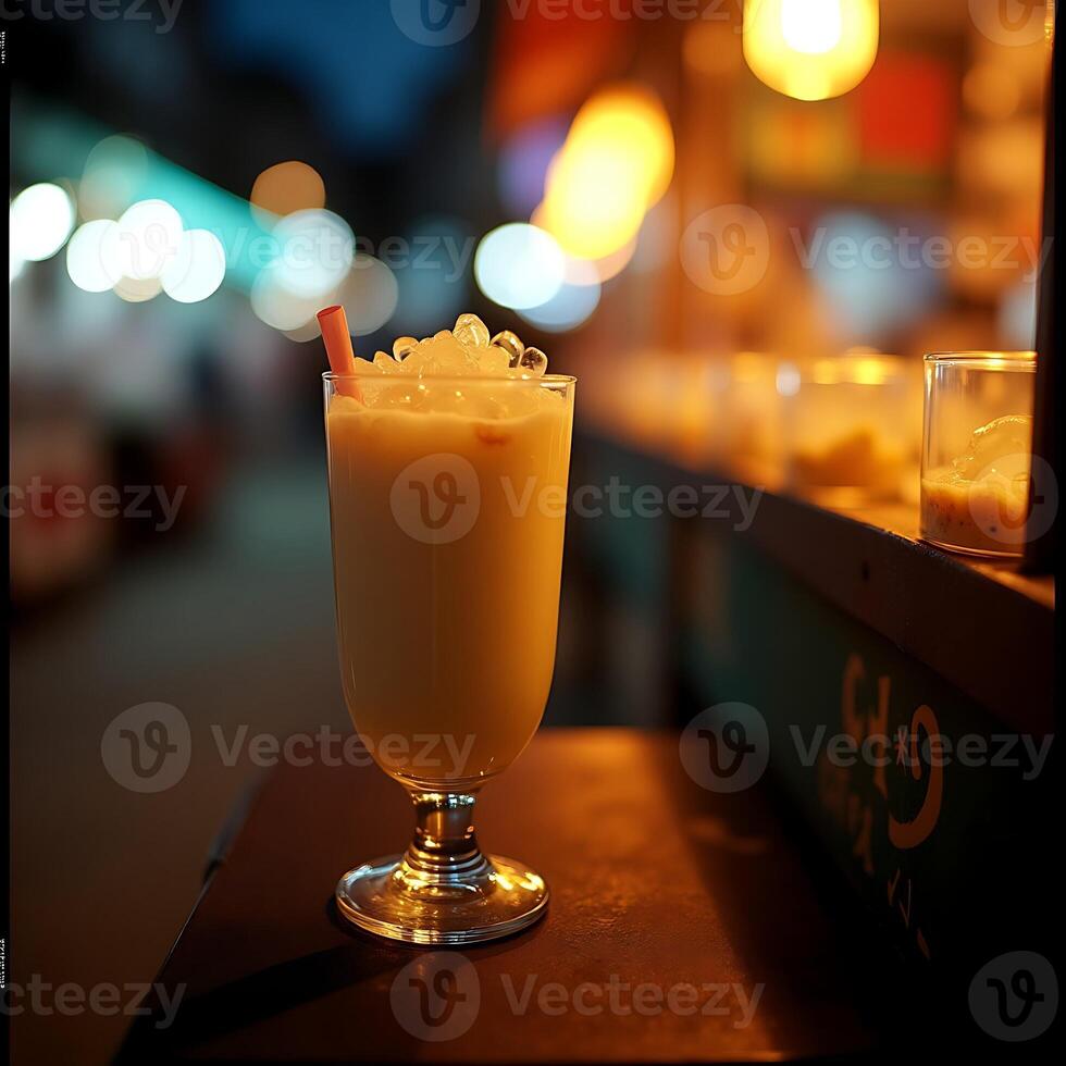 Enjoying Refreshing Iced Drink at Night Market Stall photo
