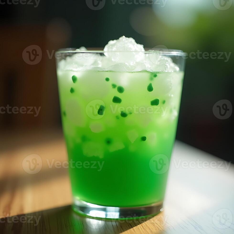 Refreshing Green Drink with Ice Close-up in a Glass photo