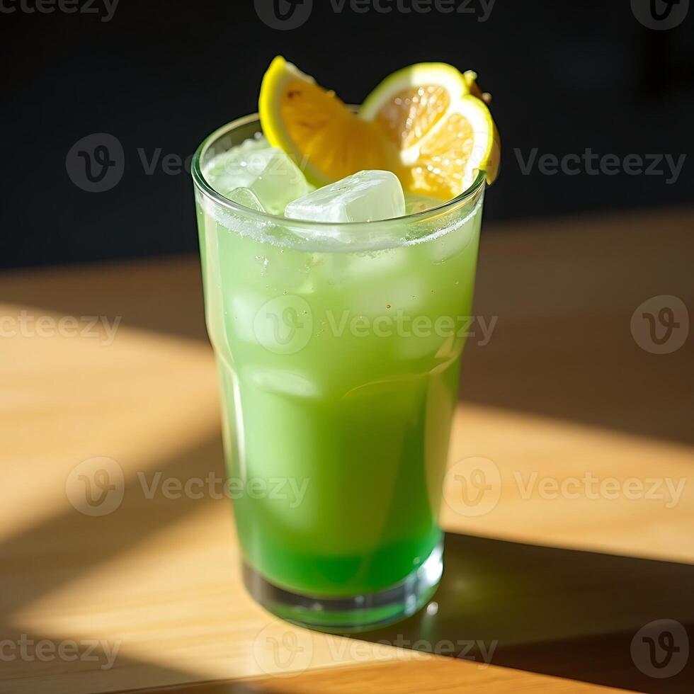 Refreshing Green Drink with Lemon and Ice on Sunny Table photo