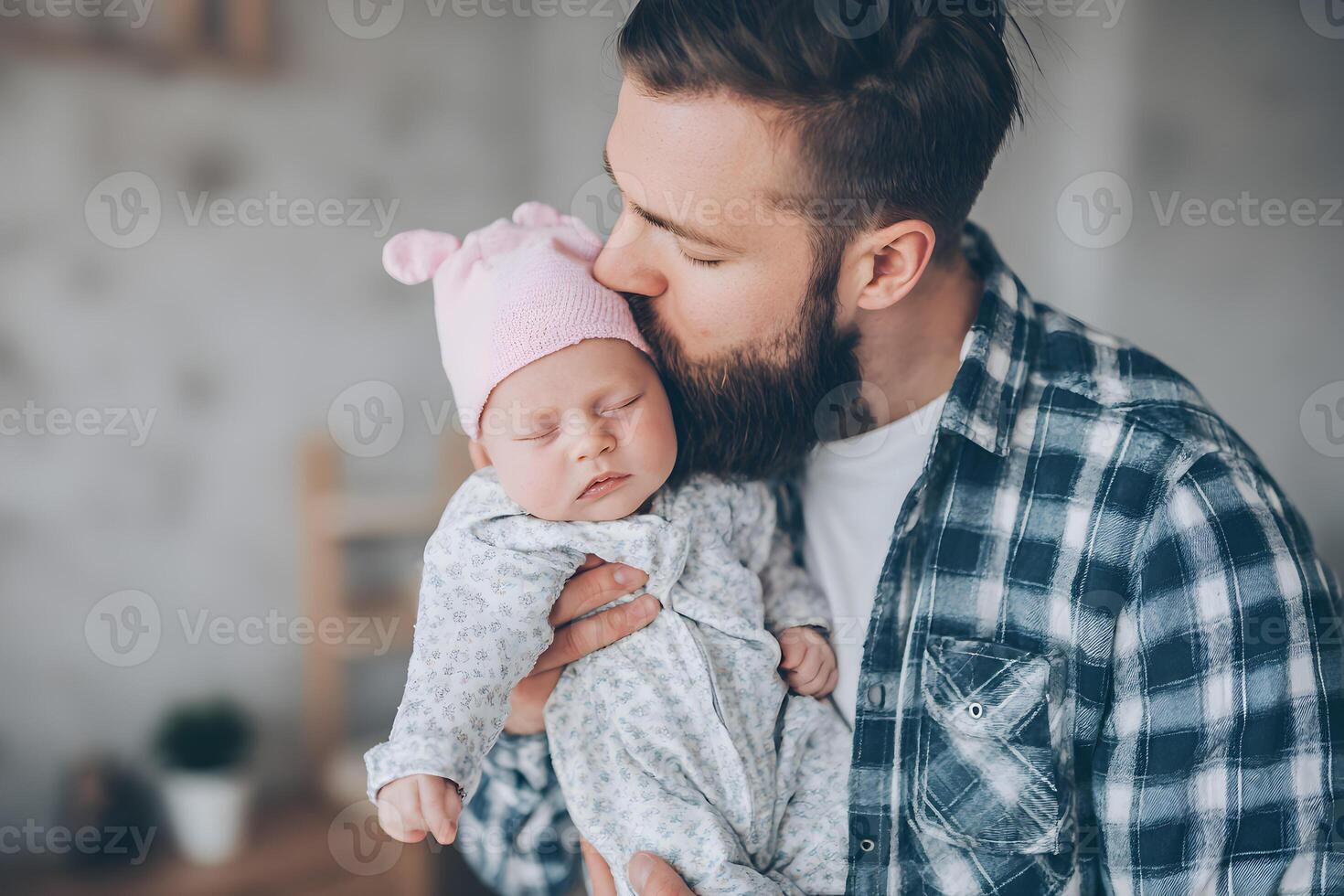 Bearded Father Gently Kissing Sleeping Baby Girl in Pink Hat photo