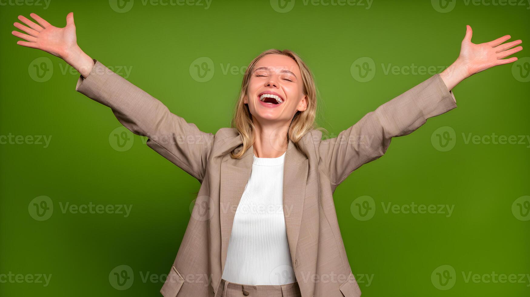 Happy Blonde Woman in Beige Blazer Open Arms Green Background photo