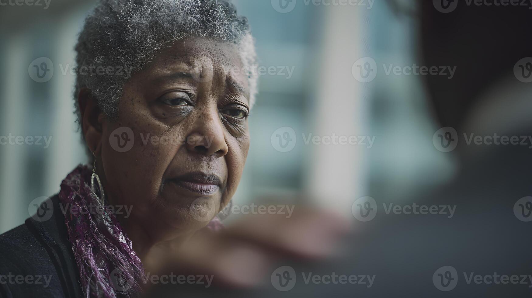Elderly Black Woman Serious Expression Comforting Hand photo