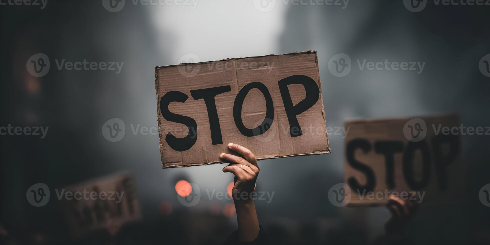 Person Holding Stop Sign at Protest Demonstration Crowd photo