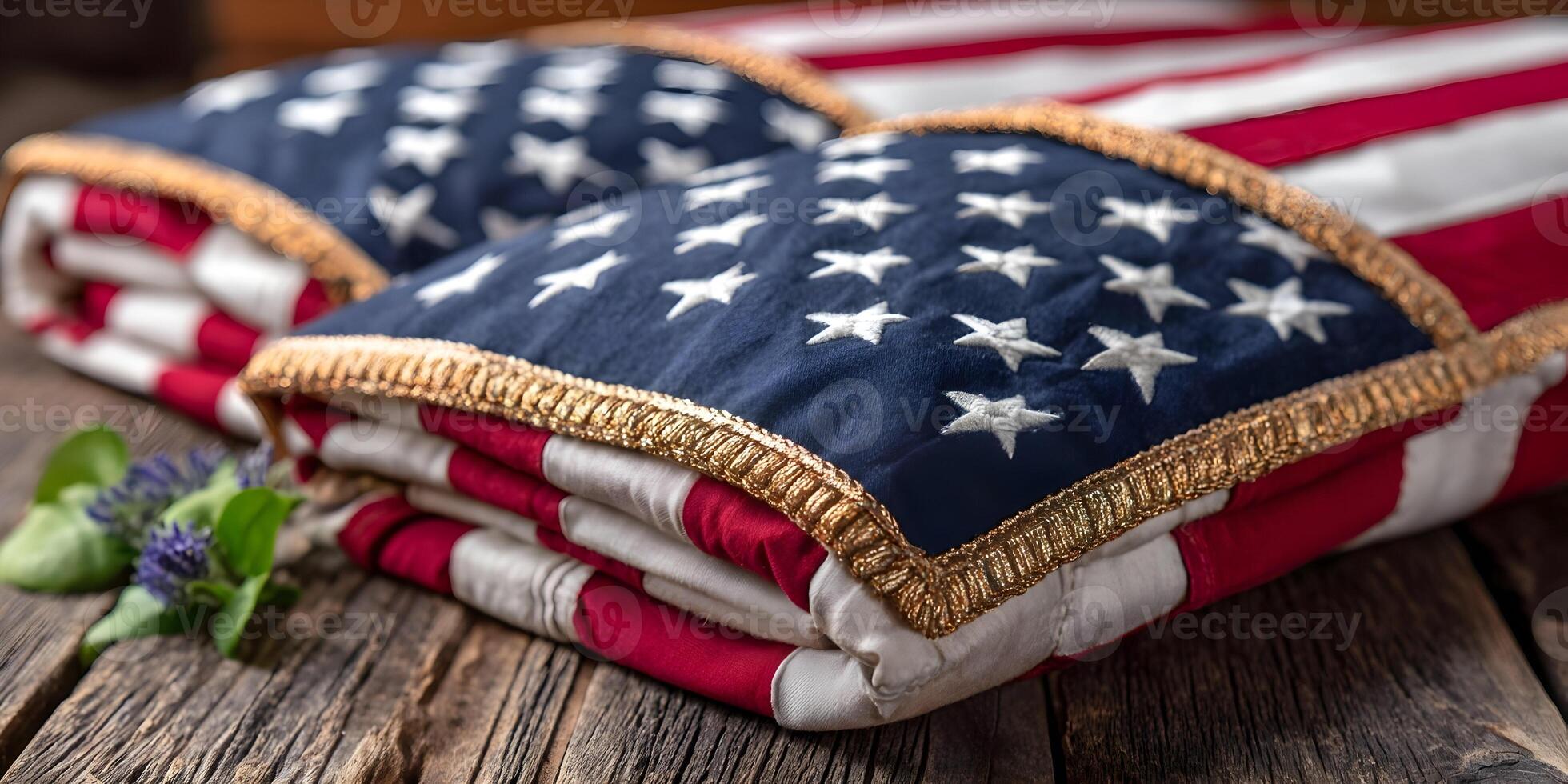 Folded American Flags with Gold Fringe on Wooden Surface photo