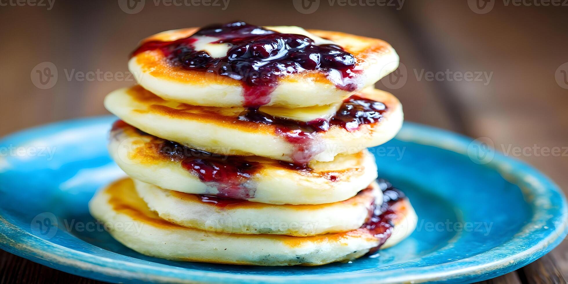 Stack of Pancakes with Blueberry Jam and Butter on Blue Plate photo