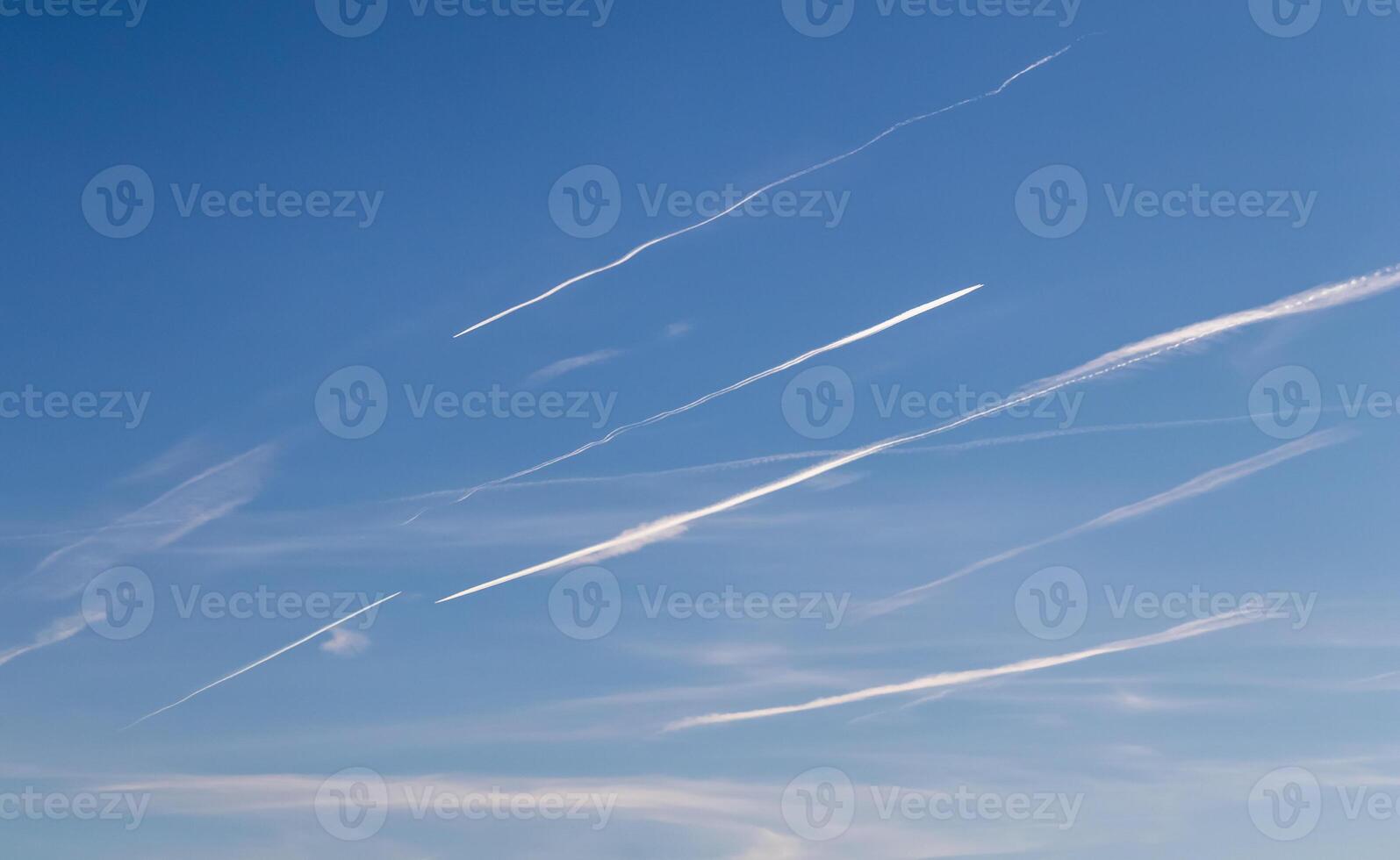 Contrails - a flying transport airplanes with condensation trails in the a sky photo