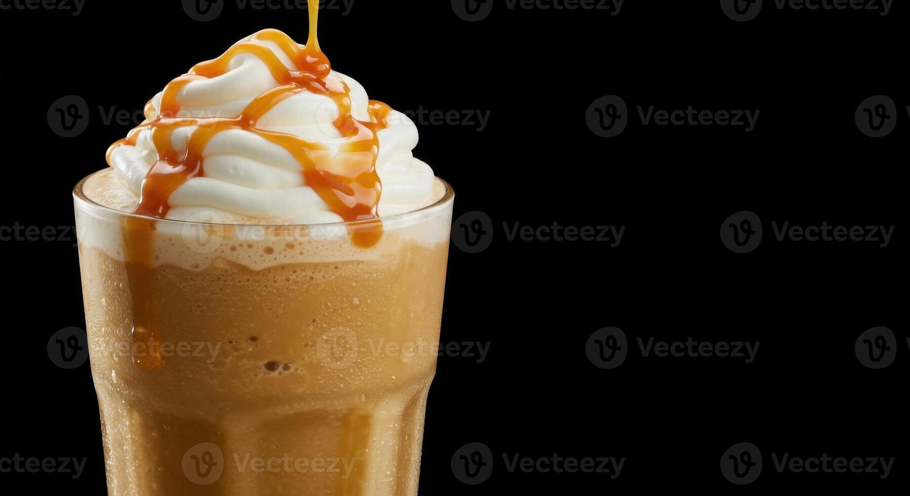 A refreshing cold caramel coffee drink, topped with whipped cream and caramel drizzle. photo