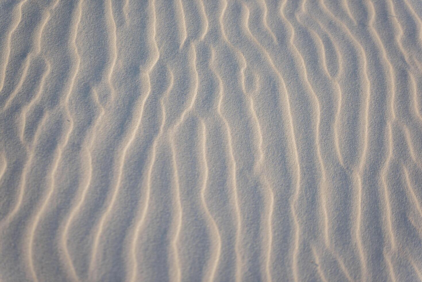 A close up of sand dunes with wavy lines photo