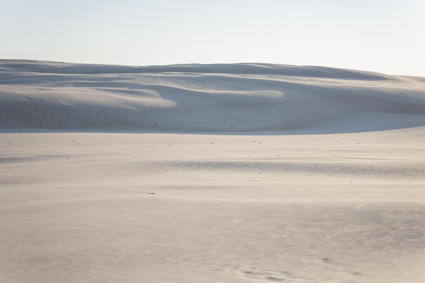 A person is standing on top of a snow covered field photo