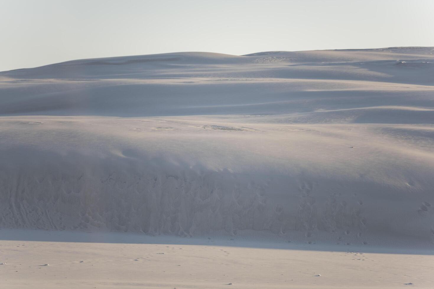 A person is riding a snowboard down a snowy hill photo