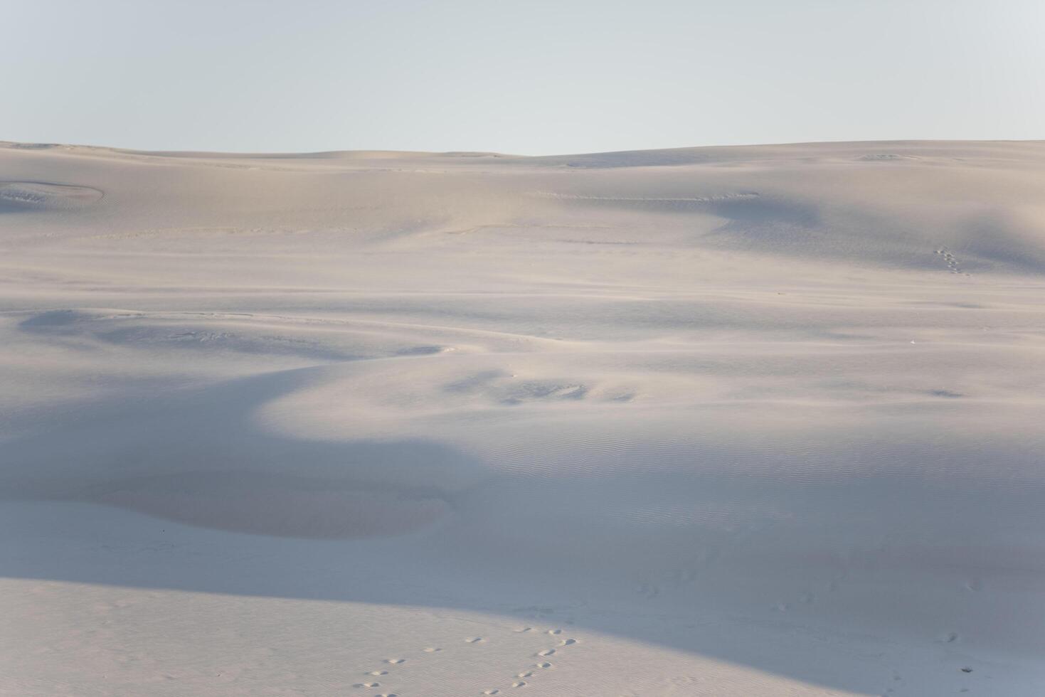 A person walking across a snowy field photo