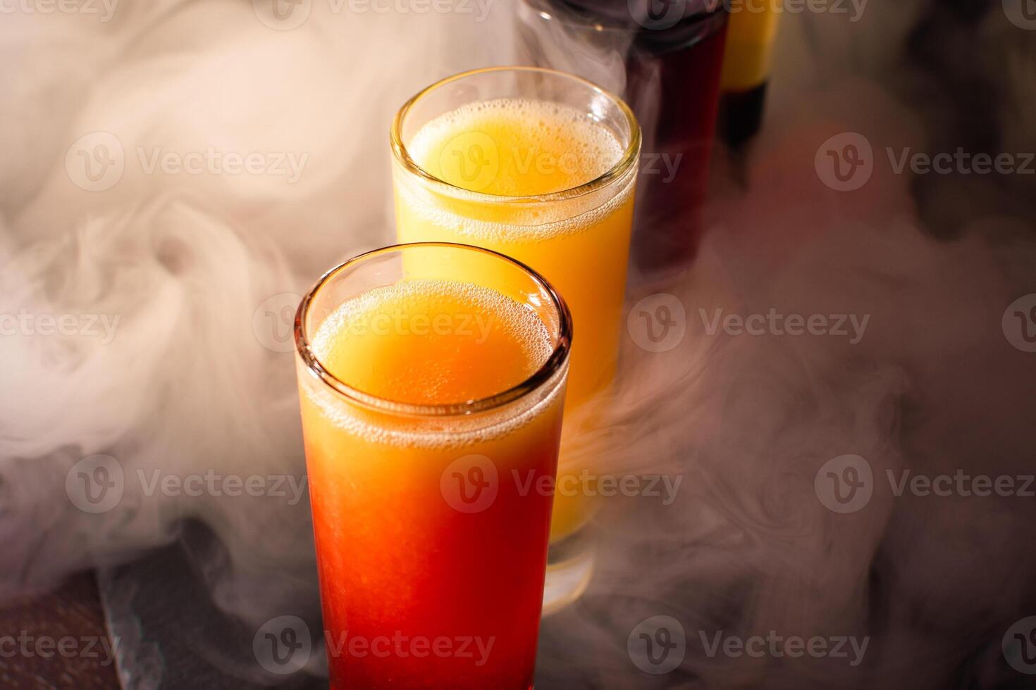 a group of five glasses of different colored drinks photo