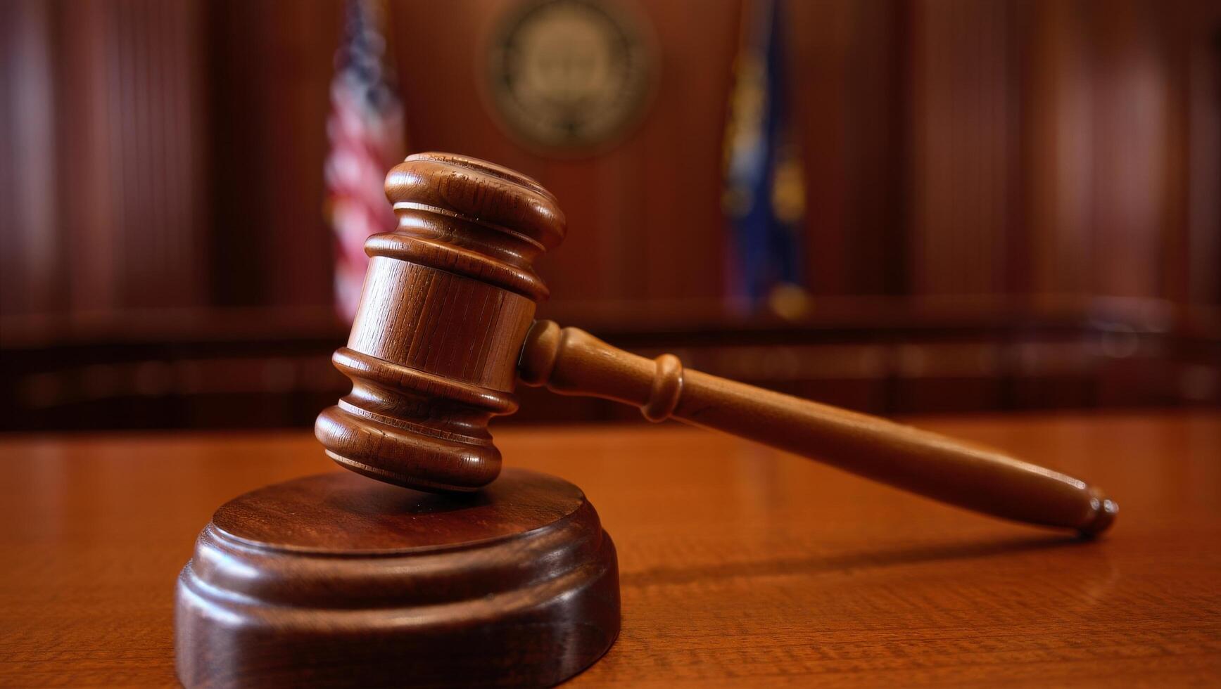 Wooden judges gavel hitting block with shallow depth of field photo