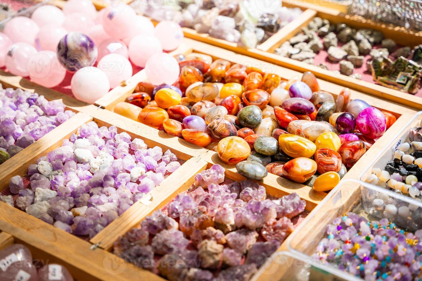 Stall filled with various precious and semi precious stones and crystals Altai Russia. Colorful collection of natural minerals for sale and display. High quality photo