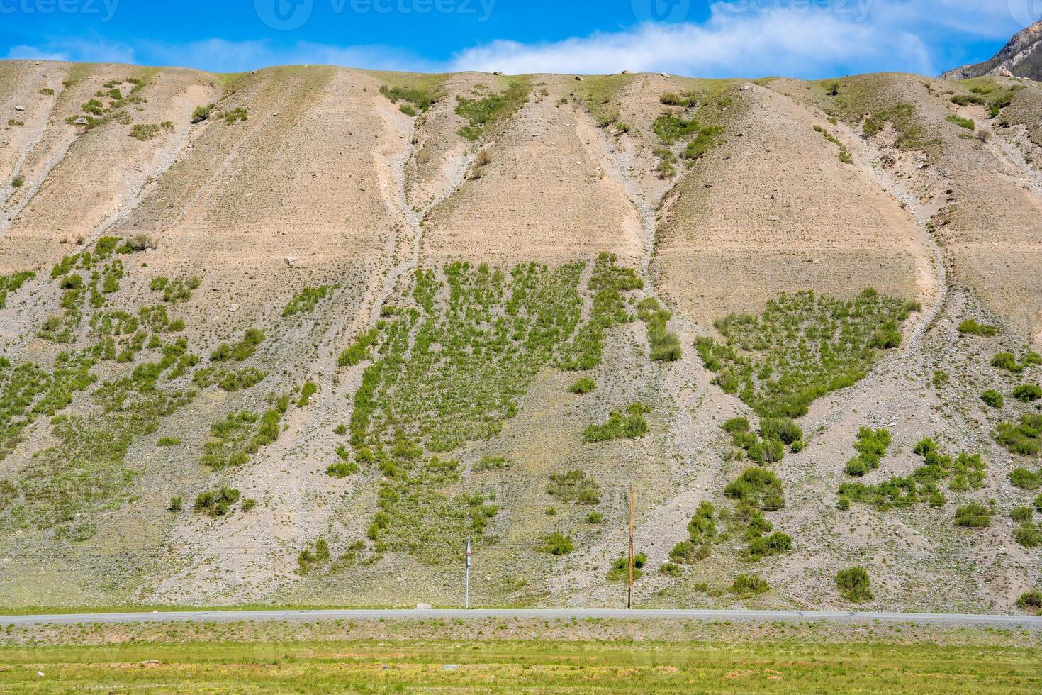 Mountain with visible geological layers indicating ancient sea near Chuysky Trakt Altai Russia. Natural rock formation revealing prehistoric marine history. High quality photo