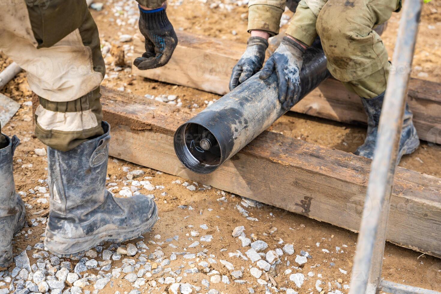 Opening of container with soil sample extracted from borehole. Preparation of core material for visual inspection and laboratory testing. High quality photo