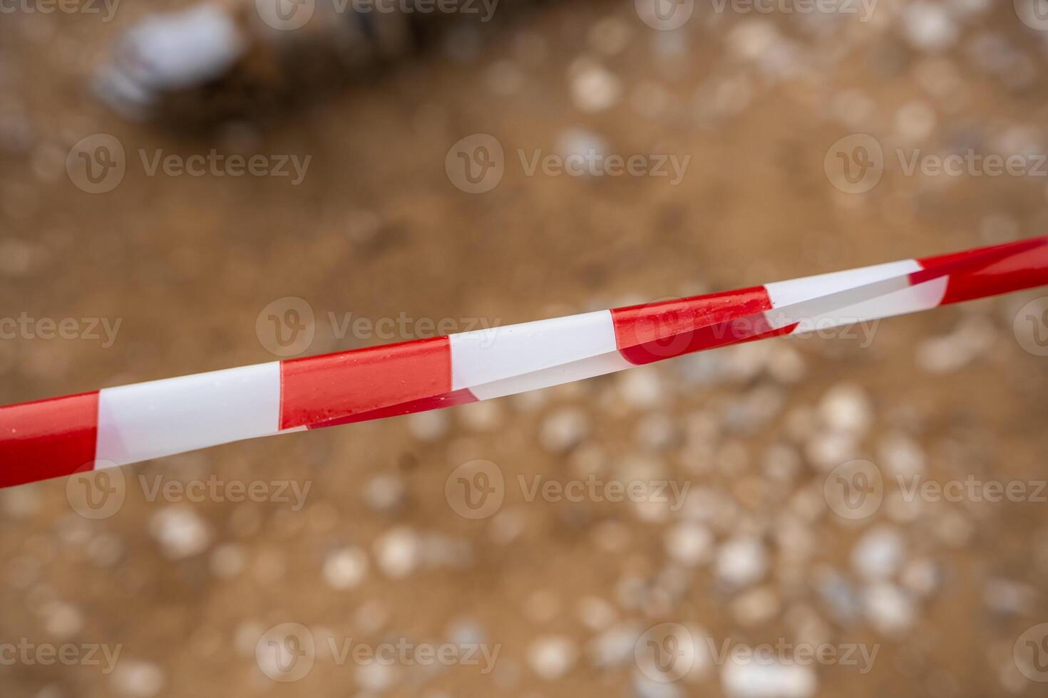 Red and white warning tape stretched across a restricted construction area. Symbol of safety measures, site control, and hazard prevention. High quality photo