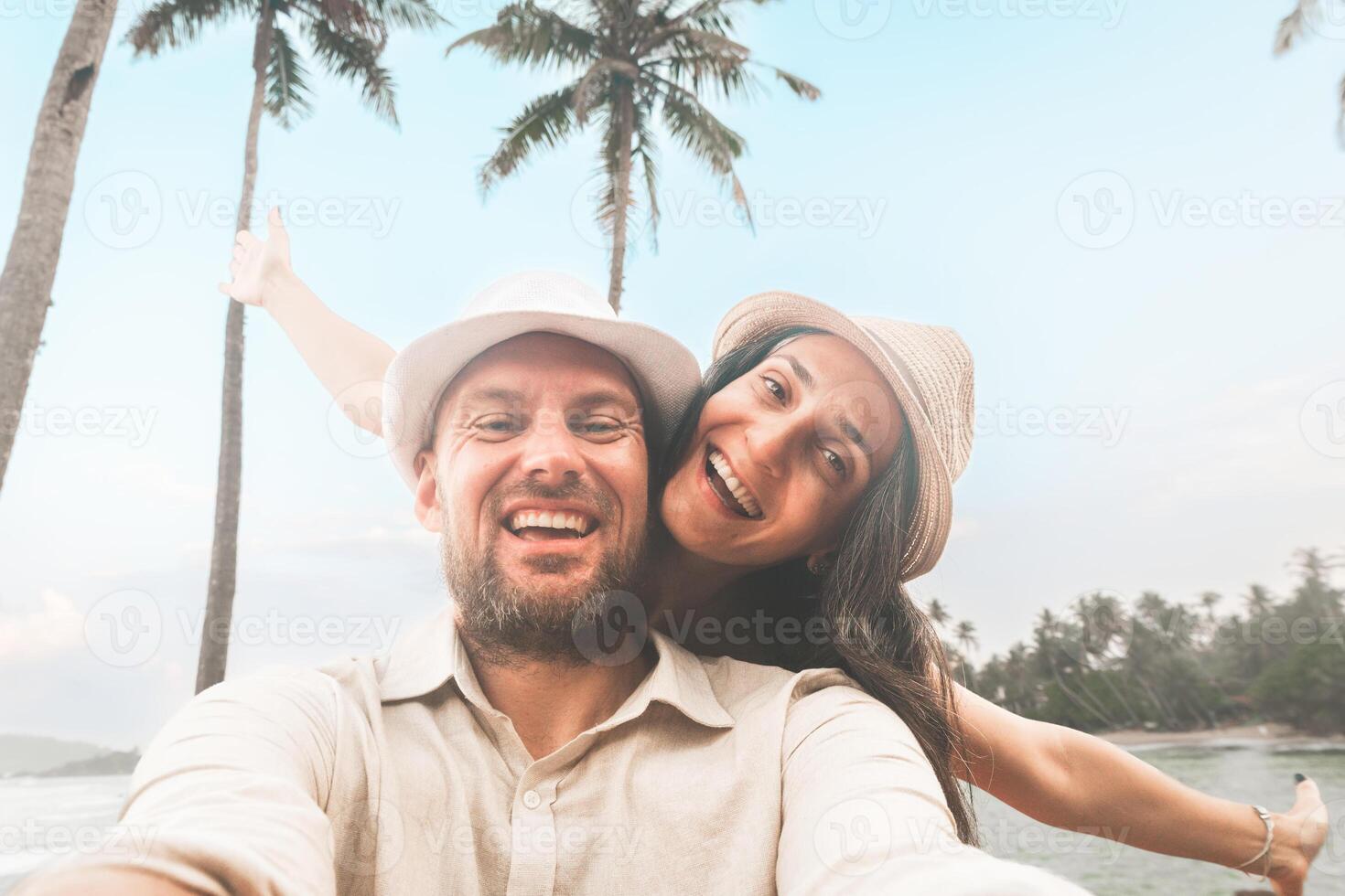 Happy couple of travelers taking selfie pic in tropical island - Two cheerful tourists visiting asia - Holidays, sport, leisure and technology life style travel concept photo