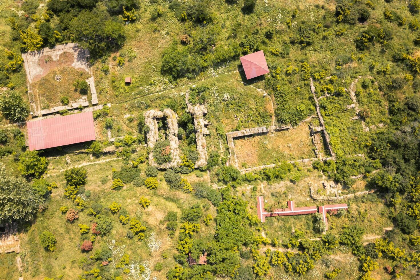 Panoramic aerial top down view of Armaziskhevi ruins with Mtskheta town, Svetitskhoveli Cathedral, and surrounding Caucasus hills in summer. photo