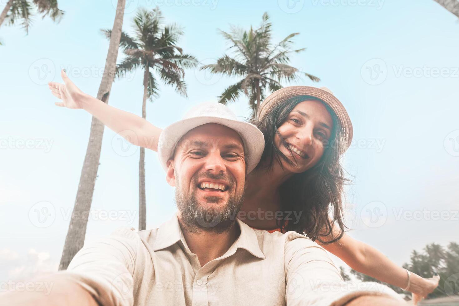 Happy couple of travelers taking selfie pic in tropical island - Two cheerful tourists visiting asia - Holidays, sport, leisure and technology life style travel concept. photo