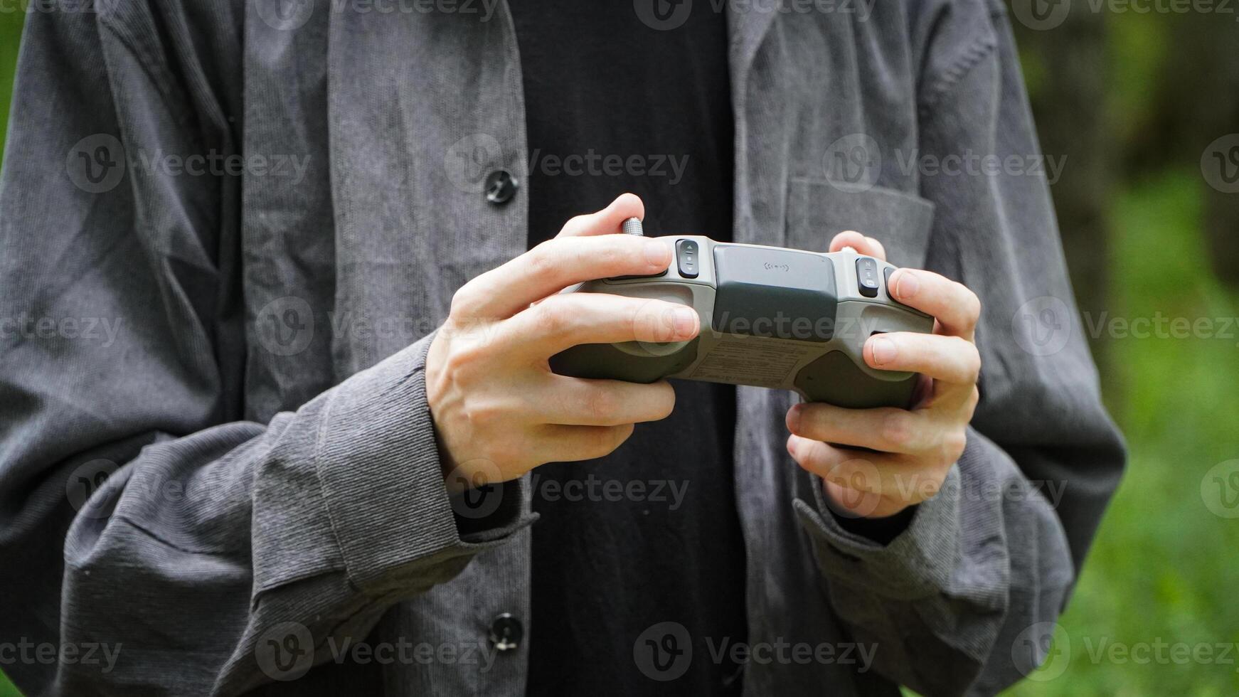 Man holding the remote control for the drone photo