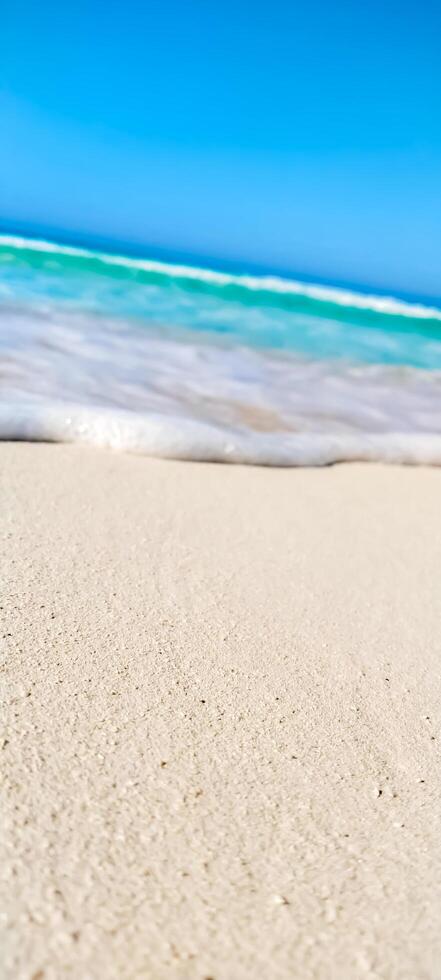 A beach with a wave coming in on the sand photo