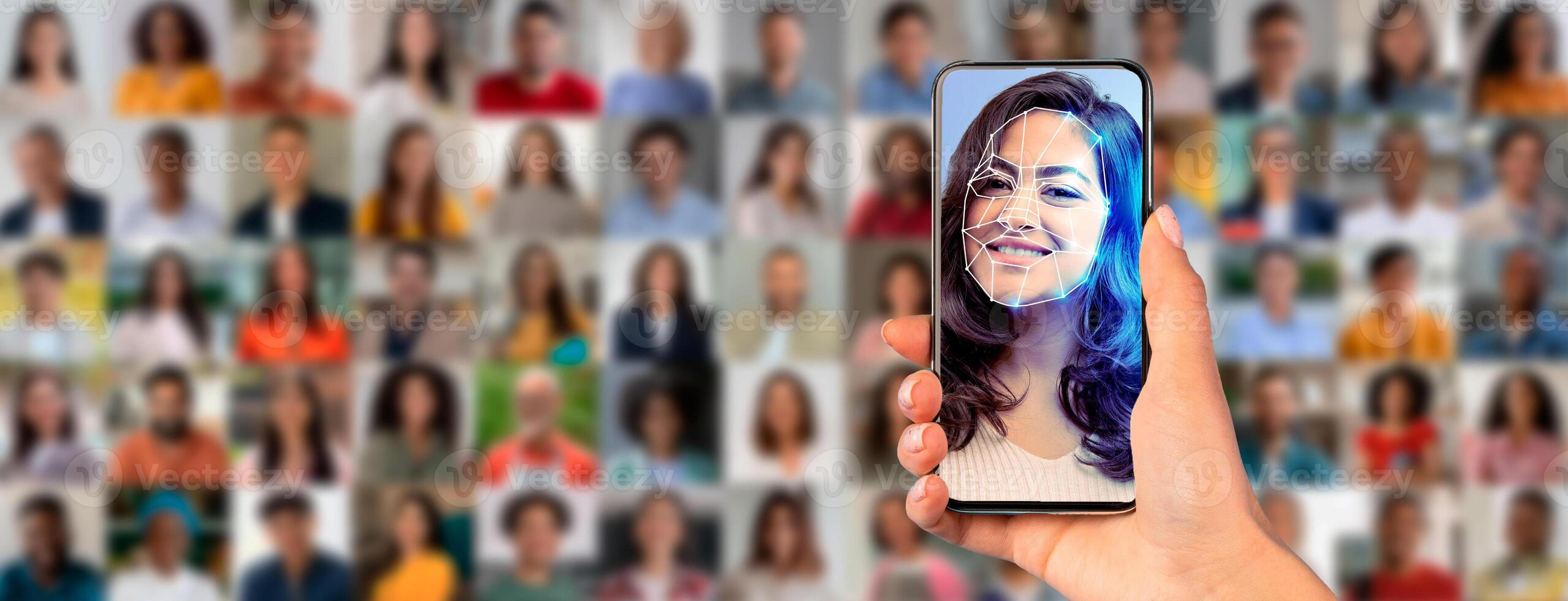 A person holds a smartphone that shows a facial recognition scan of their face. Behind them, a diverse crowd is visible, highlighting modern identification technology in action. photo
