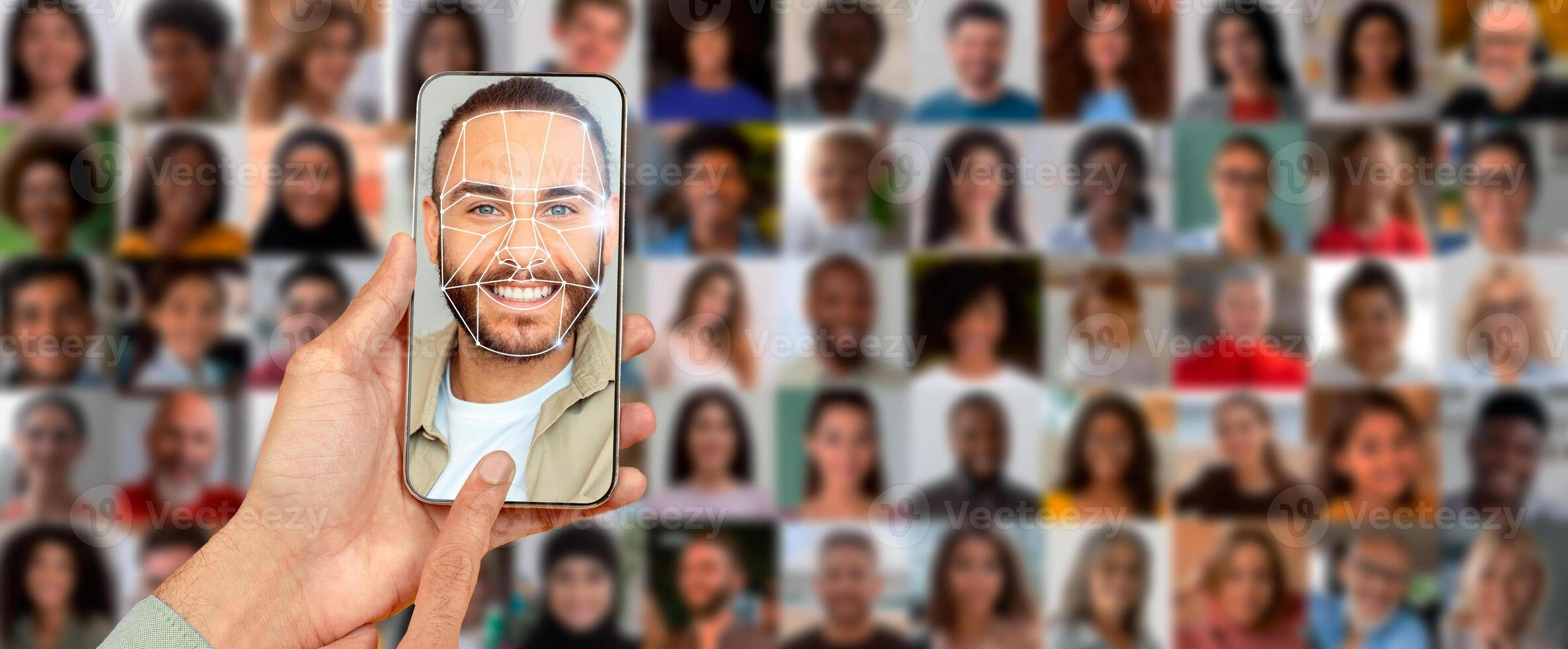 A person uses a smartphone to scan their face for identification purposes. In the background, there is a collage of various portraits showcasing diverse individuals. photo