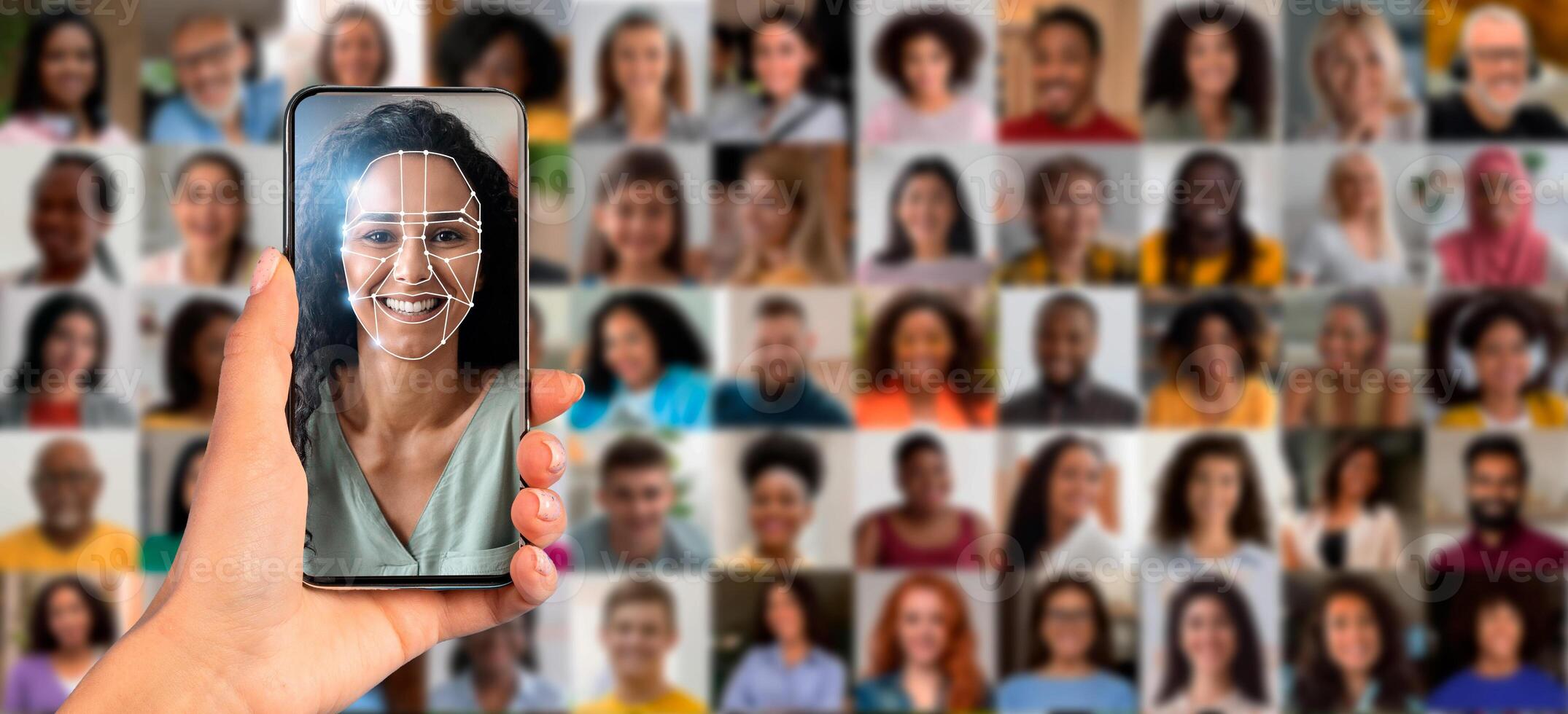 A hand holds a smartphone displaying a face scan while a collage of diverse individuals is visible in the background. This showcases the advancement in identification technology. photo
