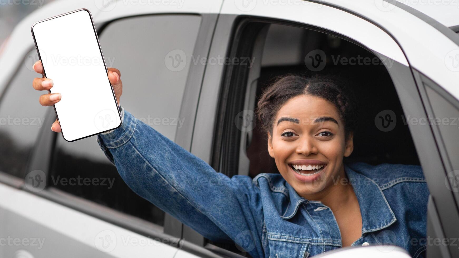 Woman taxi driver and great mood on active work. Happy young success african american female sitting in silver car and showing thumb up hand gesture in open window enjoying driving, free space photo