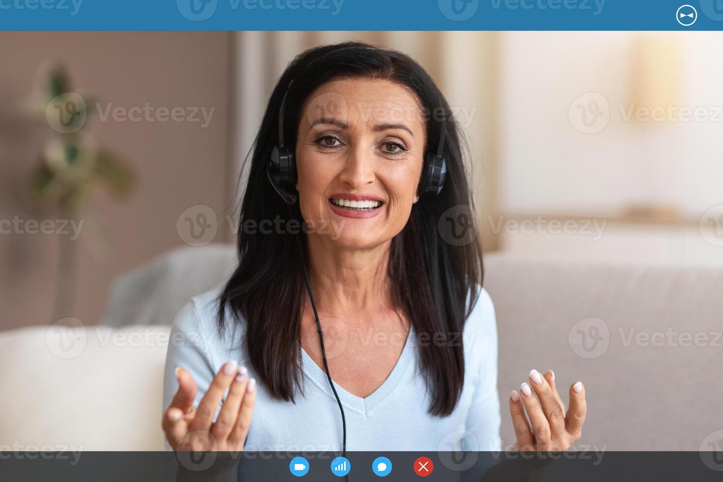 Conference. Portrait Of Senior Lady Wearing Headset Having Virtual Chat, Looking And Talking To Camera During Web Call, Explaining And Discussing Something In Headphones. Teleworking photo