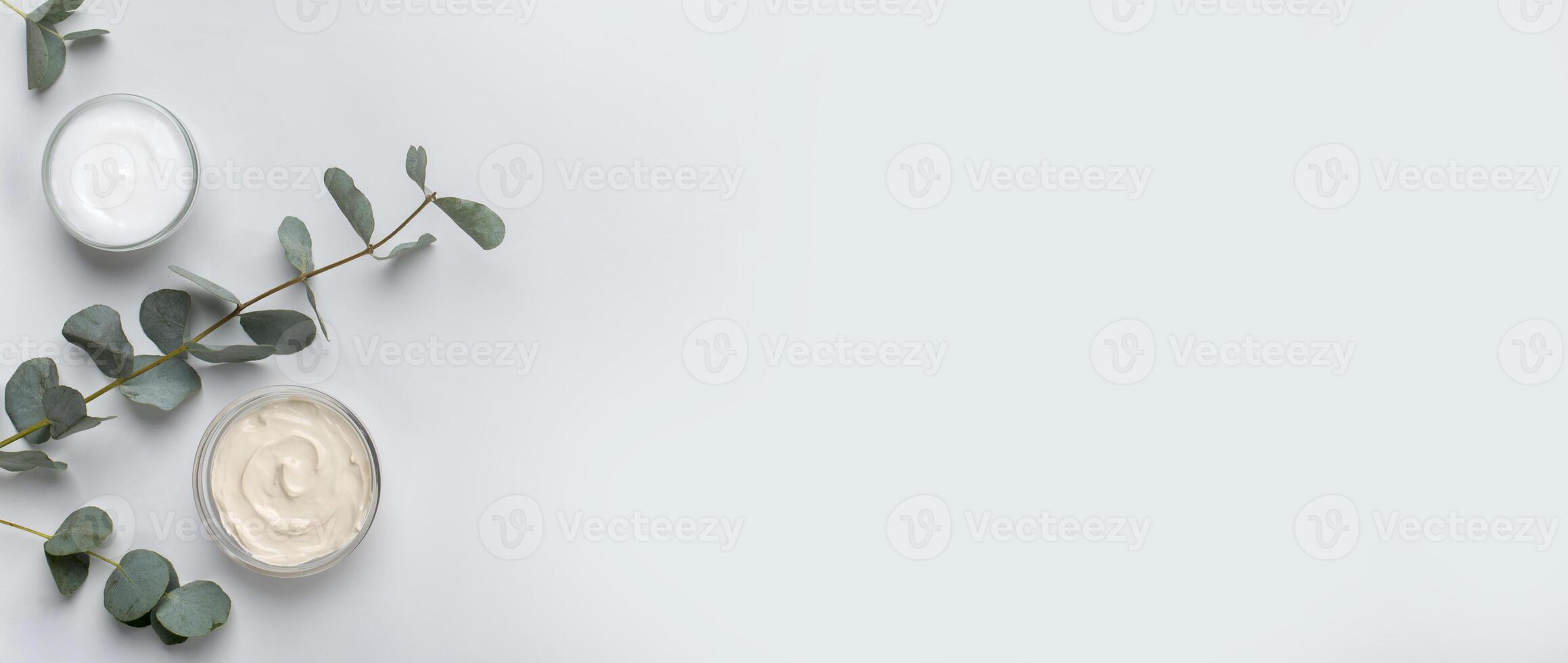 Natural body care products. Eco friendly homemade cream for face and skin on gray background, panorama, copy space photo