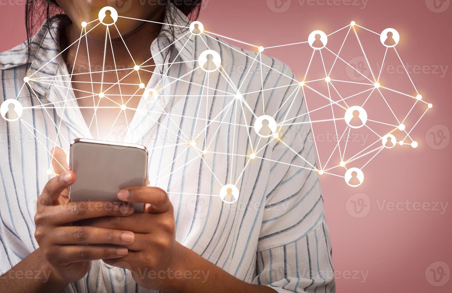 African American girl using global network or data customer connection on cellphone, pink background. Collage with web icons photo