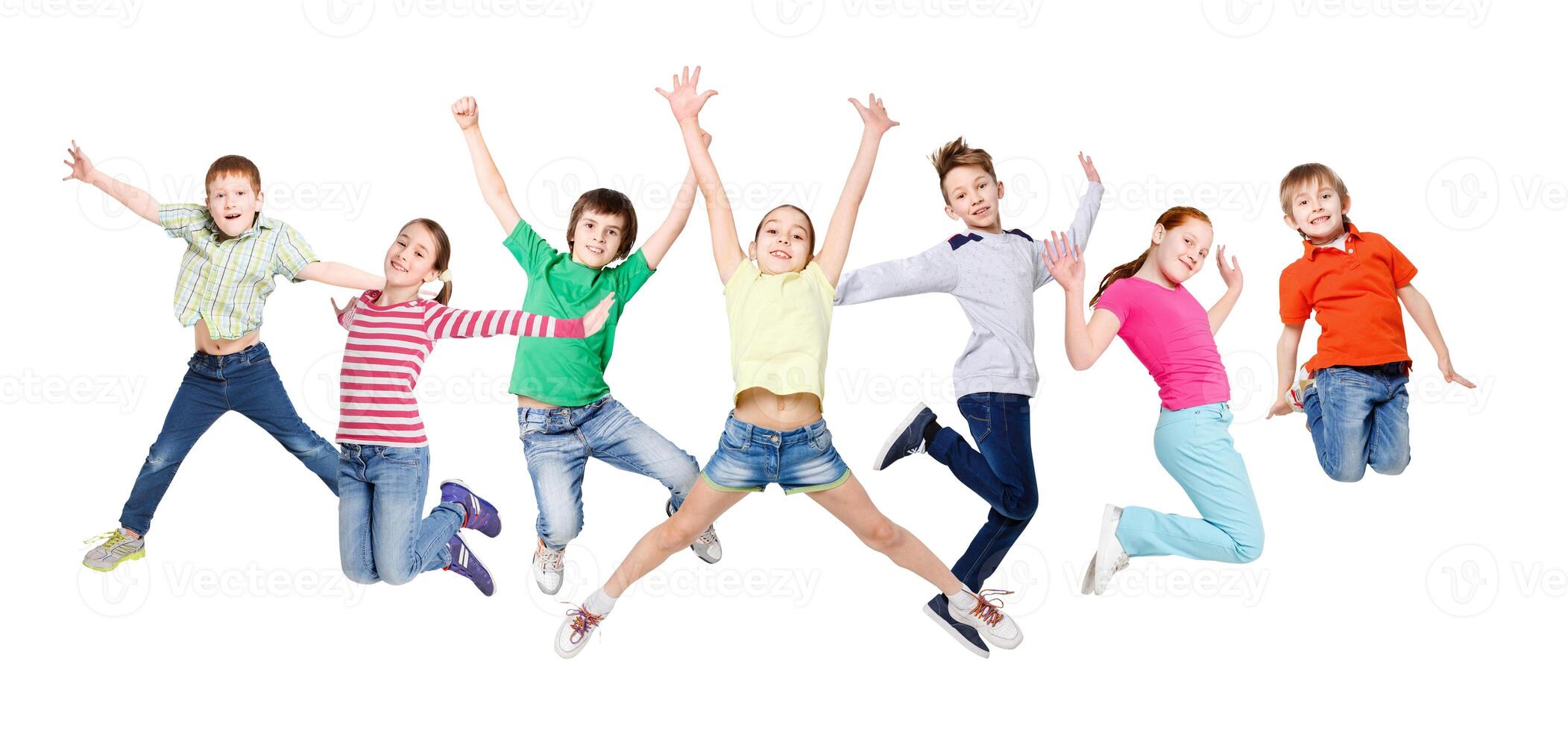 Group of happy, cheerful children jumping at isolated white studio background. Childhood and freedom, active lifestyle concept, copy space photo