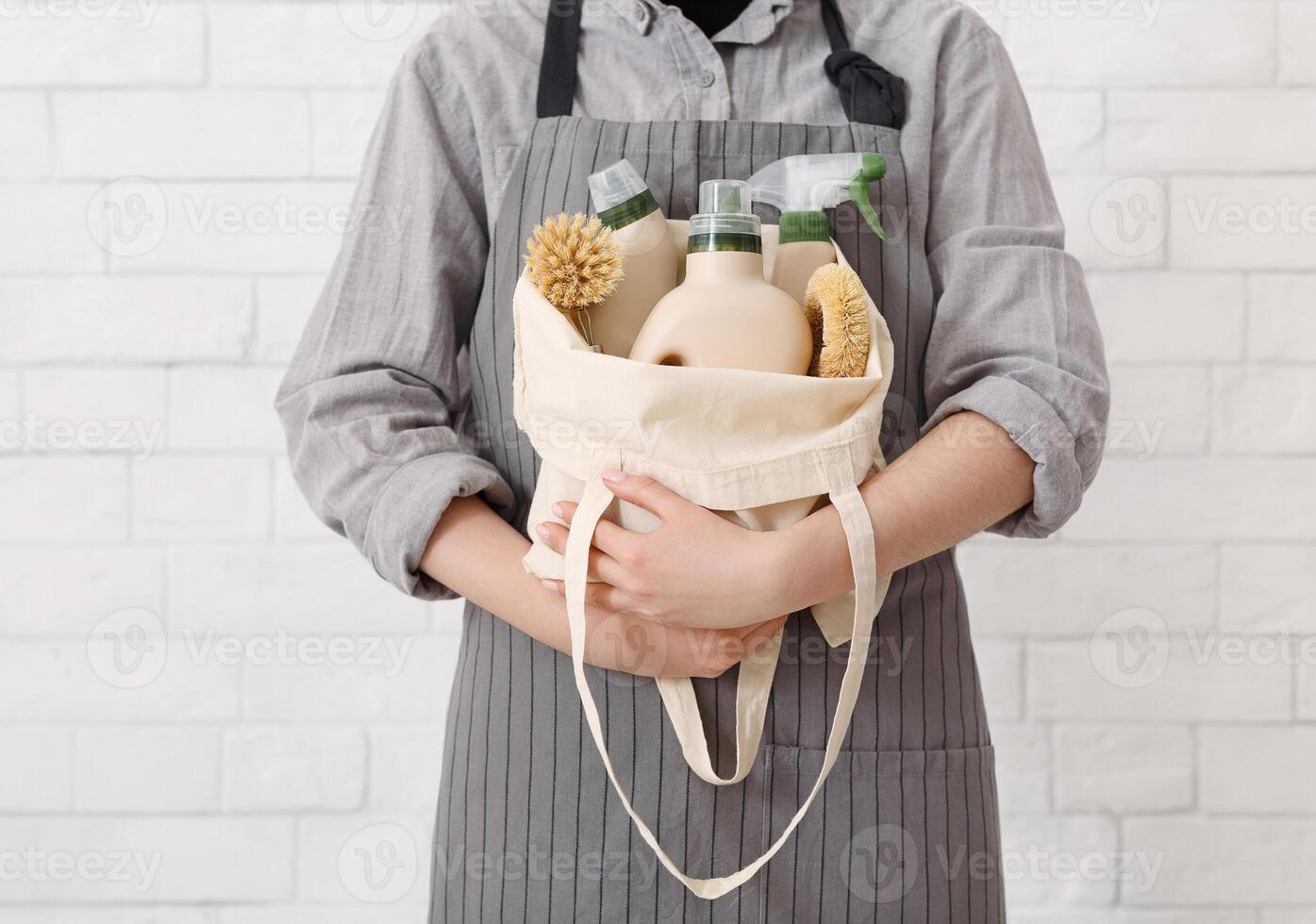 Unrecognizable woman holding Eco friendly products for home cleaning. Natural domestic cleaning, zero waste detergent photo