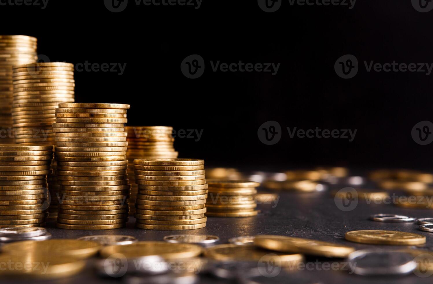 Increasing columns of gold coins on table, black background, copy space. Financial success, cryptocurrency mining, profit concept photo