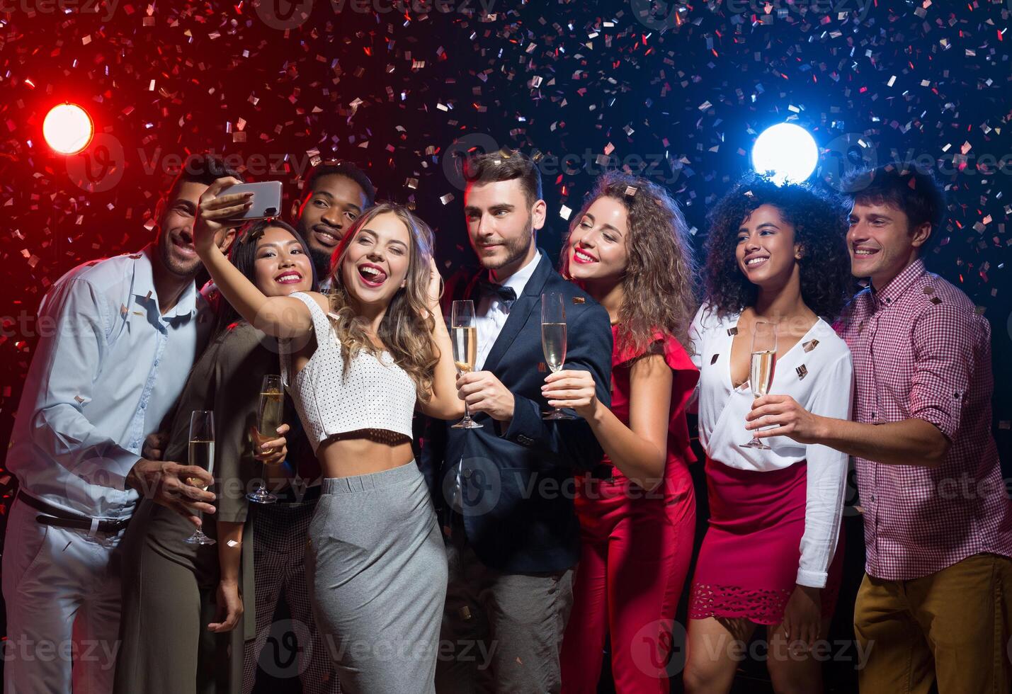 Holiday group selfie. Young friends having fun at New Year's Eve party and taking photo, copy space photo