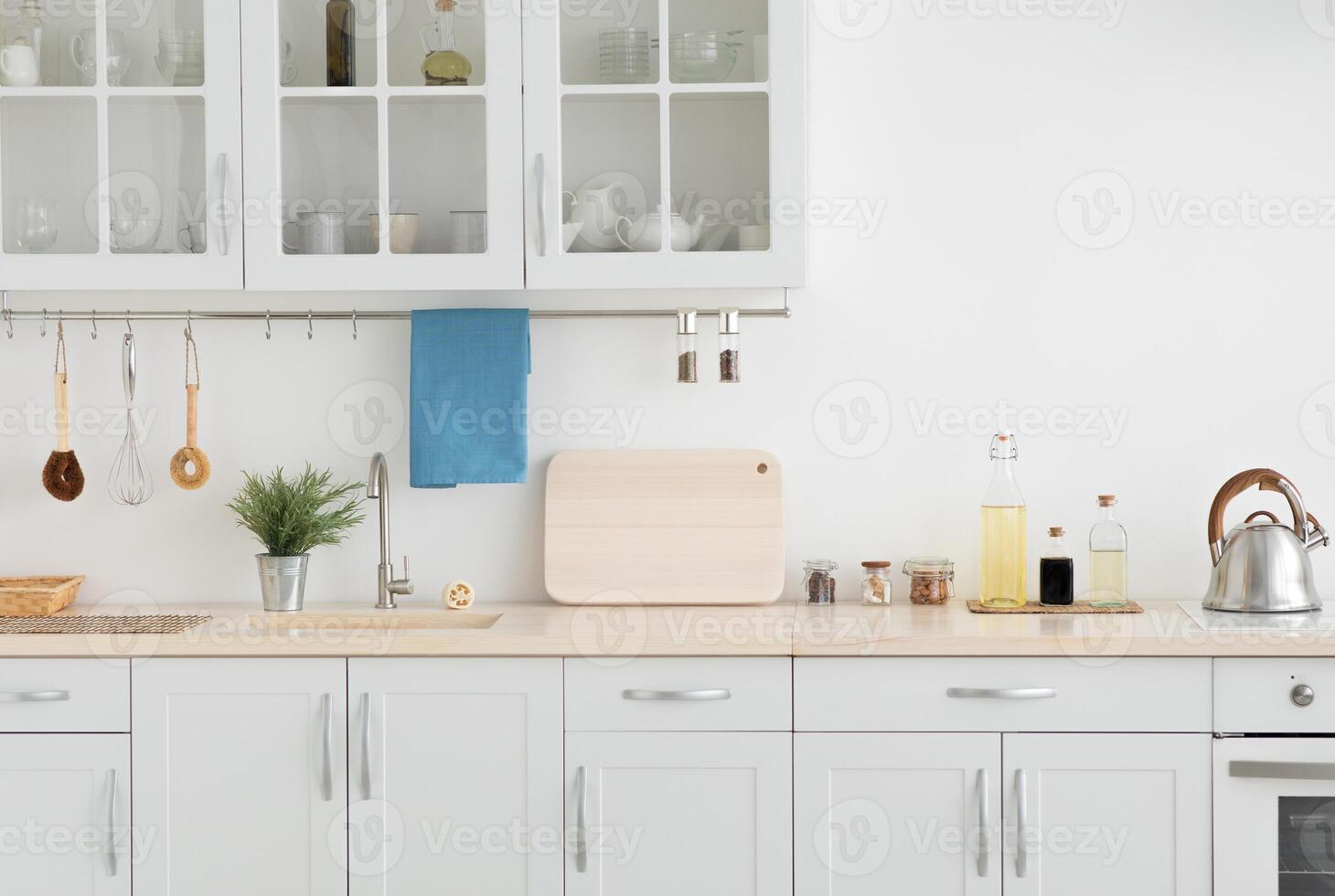 Apartment rental, new minimal, scandinavian design after renovation and modern style, flat or house for sale. White furniture with utensils, light wall in simple interior at morning, empty space photo
