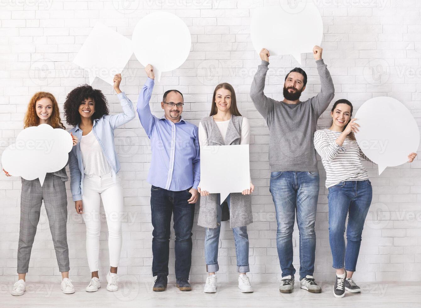 Social comments. Group of diverse people holding blank speech bubbles, empty space photo